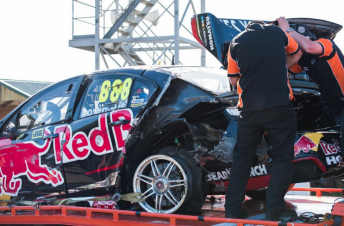 Craig Lowndes' Holden is returned to the pits