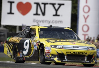 car Marcos Ambrose on his way to victory at Watkins Glen