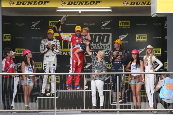 Jason Bright cradling Jason Richards' daughter Sienna and saluted by the late driver's wife Charlotte on the podium. Pic: Neville Bailey