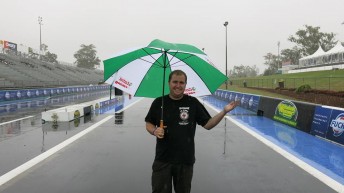 Ben Bray auditioning for a post-drag racing 'umbrella girl' career at a wet Willowbank