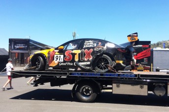 The Mazda being hauled back to its pit garage after the heavy qualifying shunt
