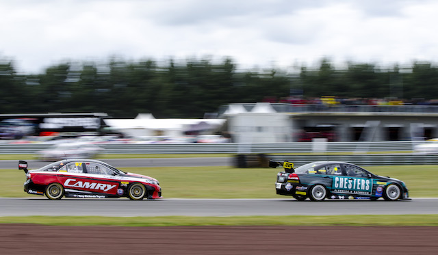 Tim Edgell in his Chesters Holden being chased down by Jason Bargwanna in his Toyota Camry at Taupo